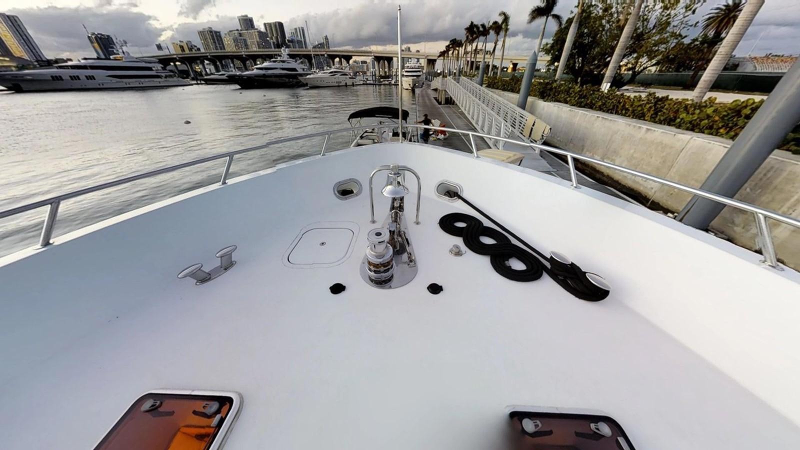 a white boat with black text aboard 92' HATTERAS Yacht for Sale