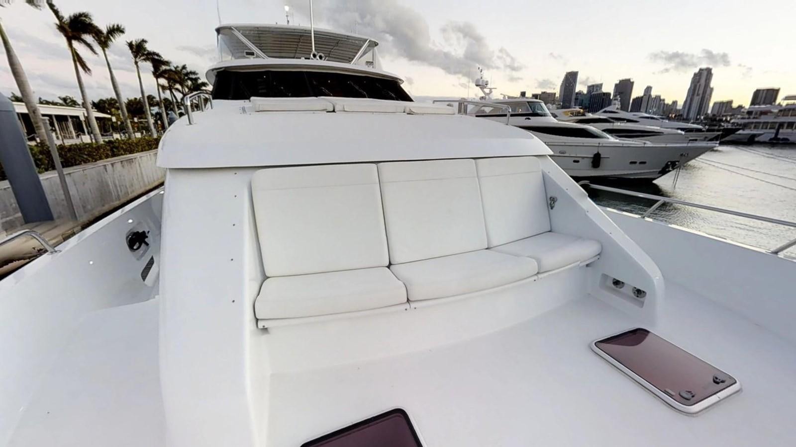 a white yacht on a dock aboard 92' HATTERAS Yacht for Sale