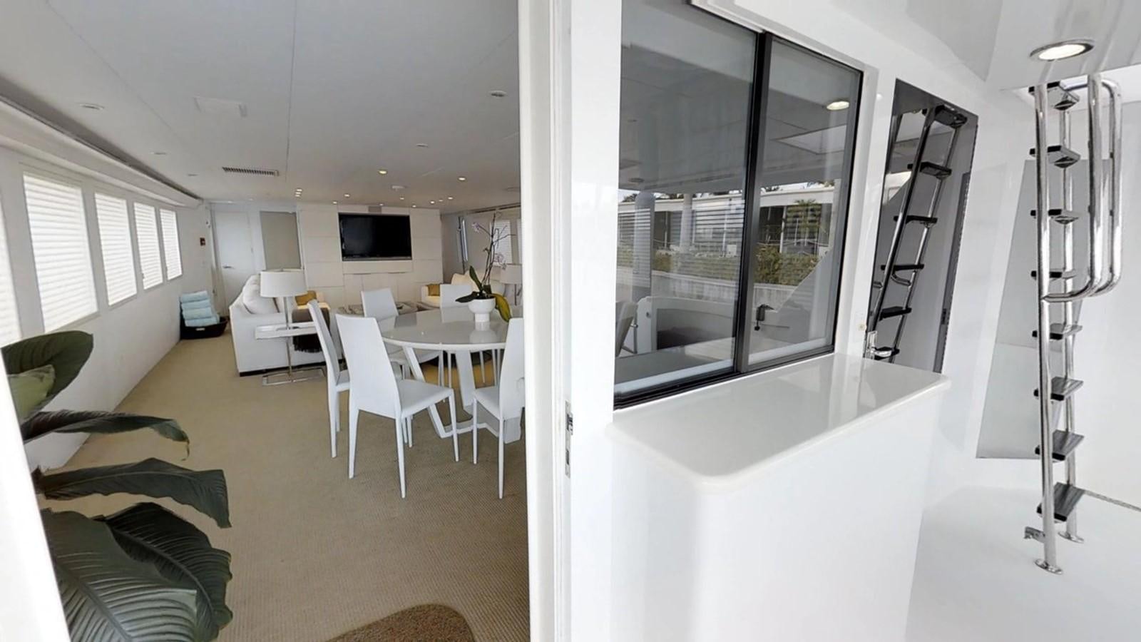 a room with a table and chairs aboard 92' HATTERAS Yacht for Sale