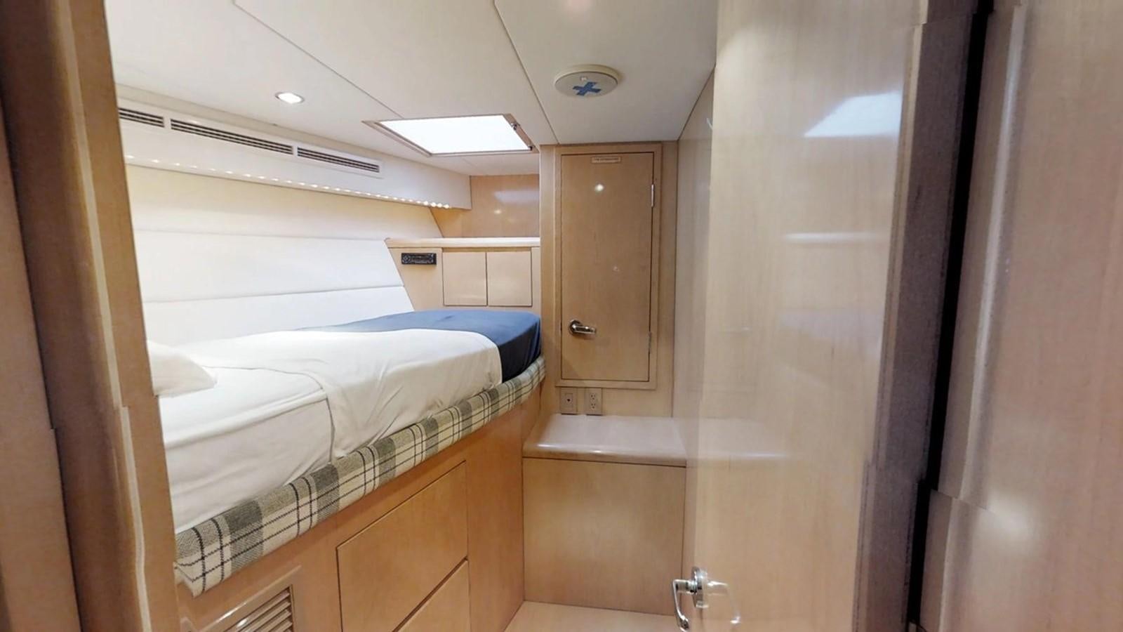 a room with a couple of beds aboard 92' HATTERAS Yacht for Sale