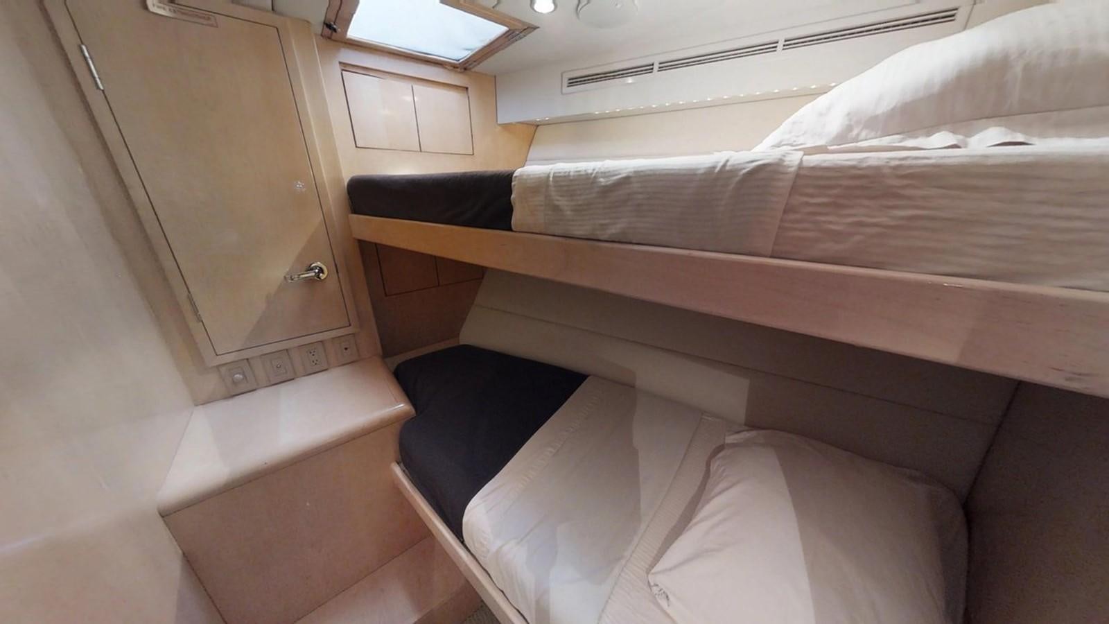 a room with a bed and a window aboard 92' HATTERAS Yacht for Sale