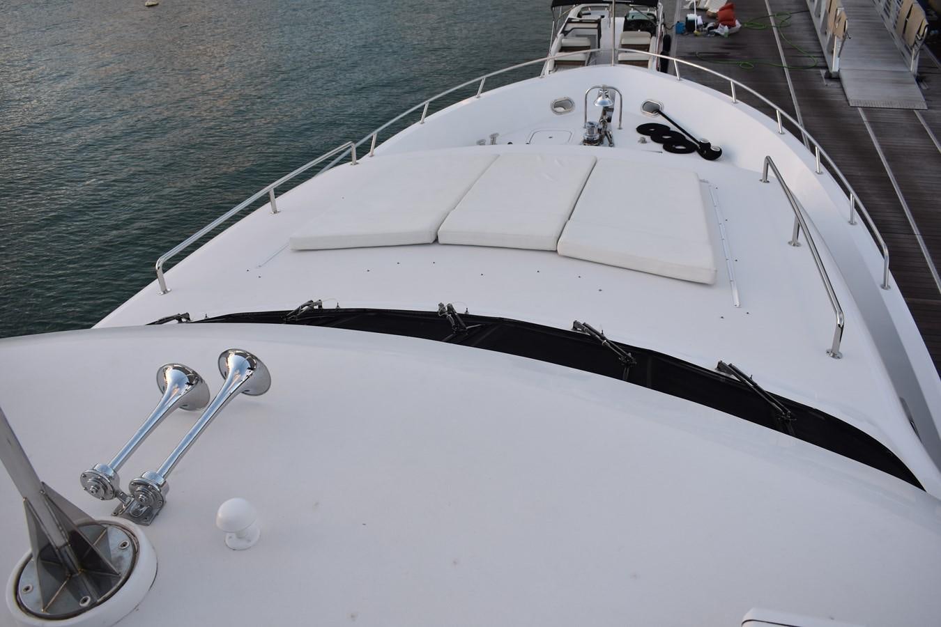 a white boat with a rope attached aboard 92' HATTERAS Yacht for Sale