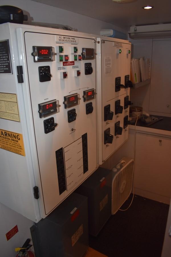 a refrigerator with magnets and pictures on it aboard 92' HATTERAS Yacht for Sale
