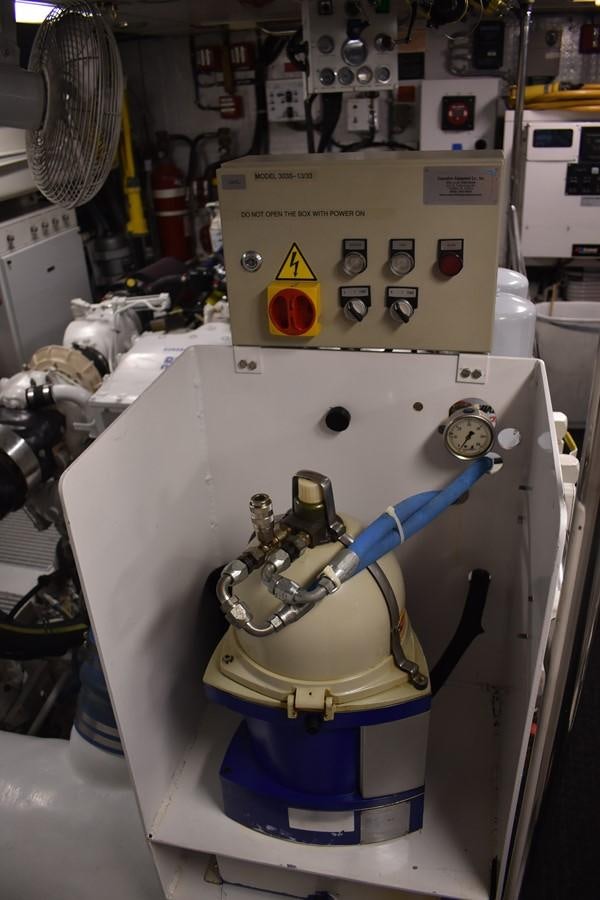 a machine with a blue and yellow label aboard 92' HATTERAS Yacht for Sale