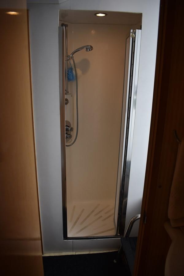 a shower unit in a bathroom aboard 92' HATTERAS Yacht for Sale