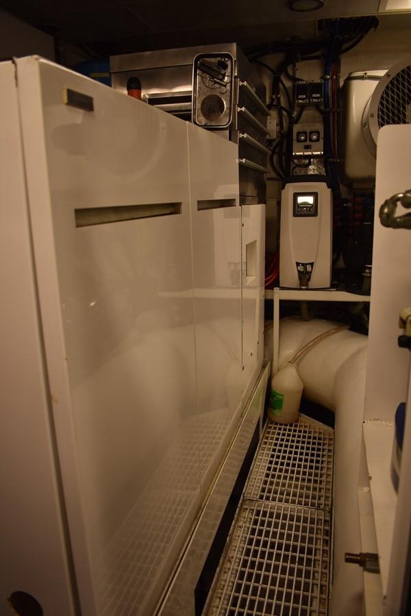 a white machine with a metal panel aboard 92' HATTERAS Yacht for Sale