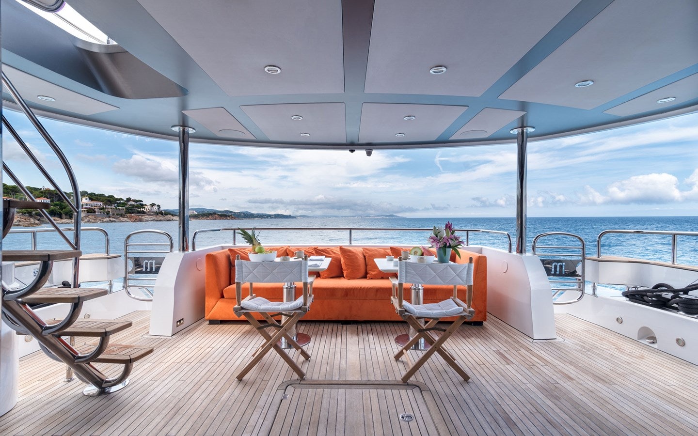a table and chairs on a deck aboard MIRKA Yacht for Charter