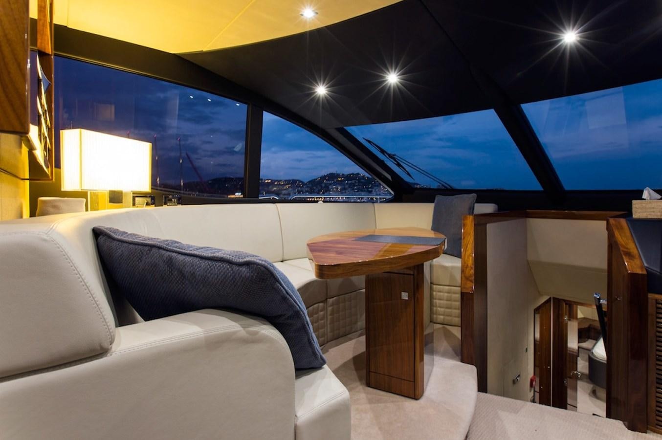 a room with a couch and a table and a tv aboard GELATO Yacht for Sale