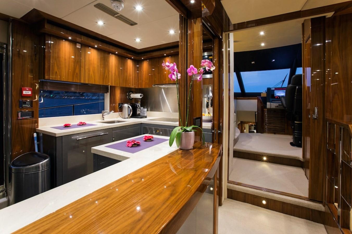 a kitchen with a counter and a plant in a pot aboard GELATO Yacht for Sale
