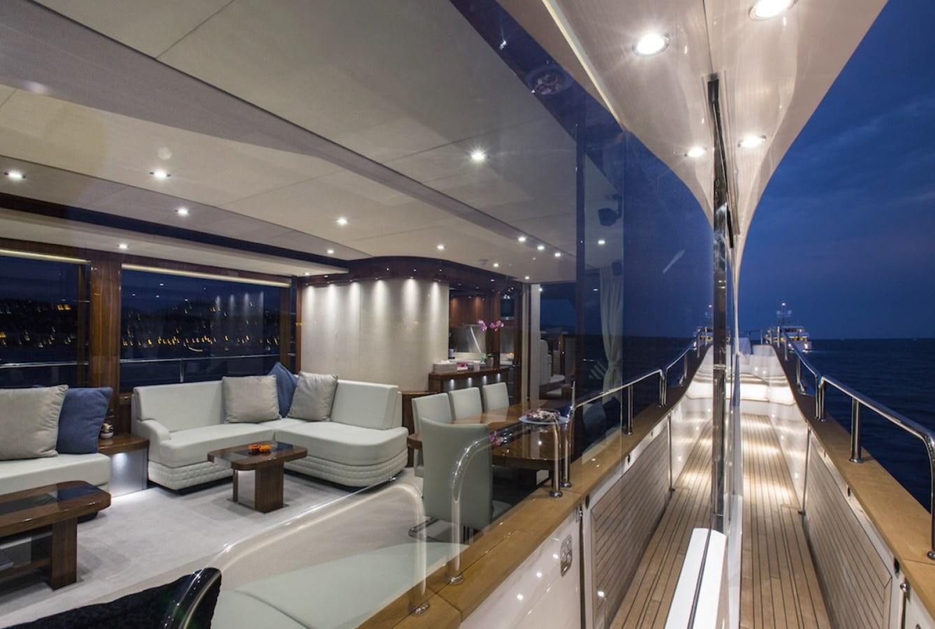 a large living room with a balcony aboard GELATO Yacht for Sale