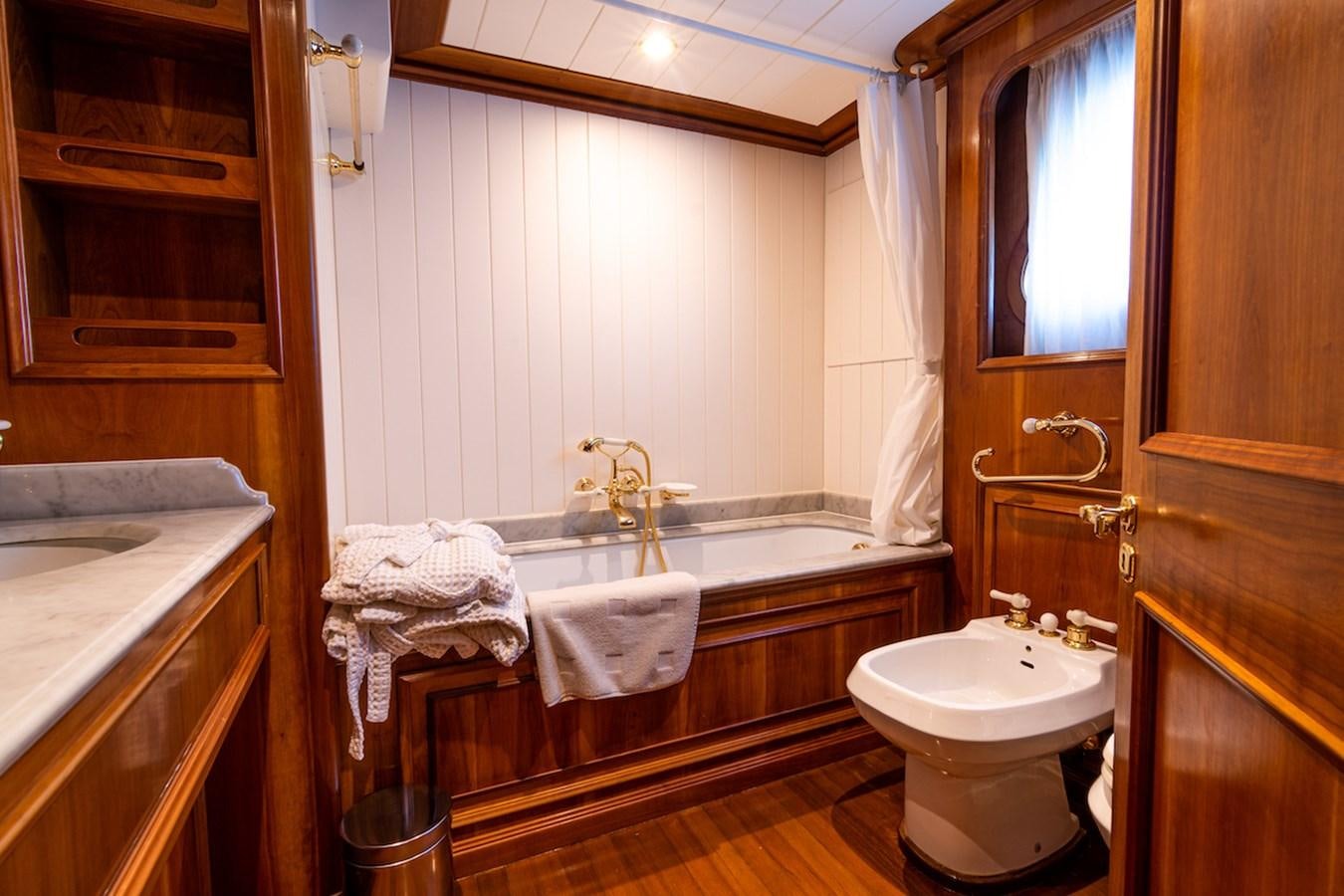 a bathroom with a tub sink and a sink aboard A&A Yacht for Sale