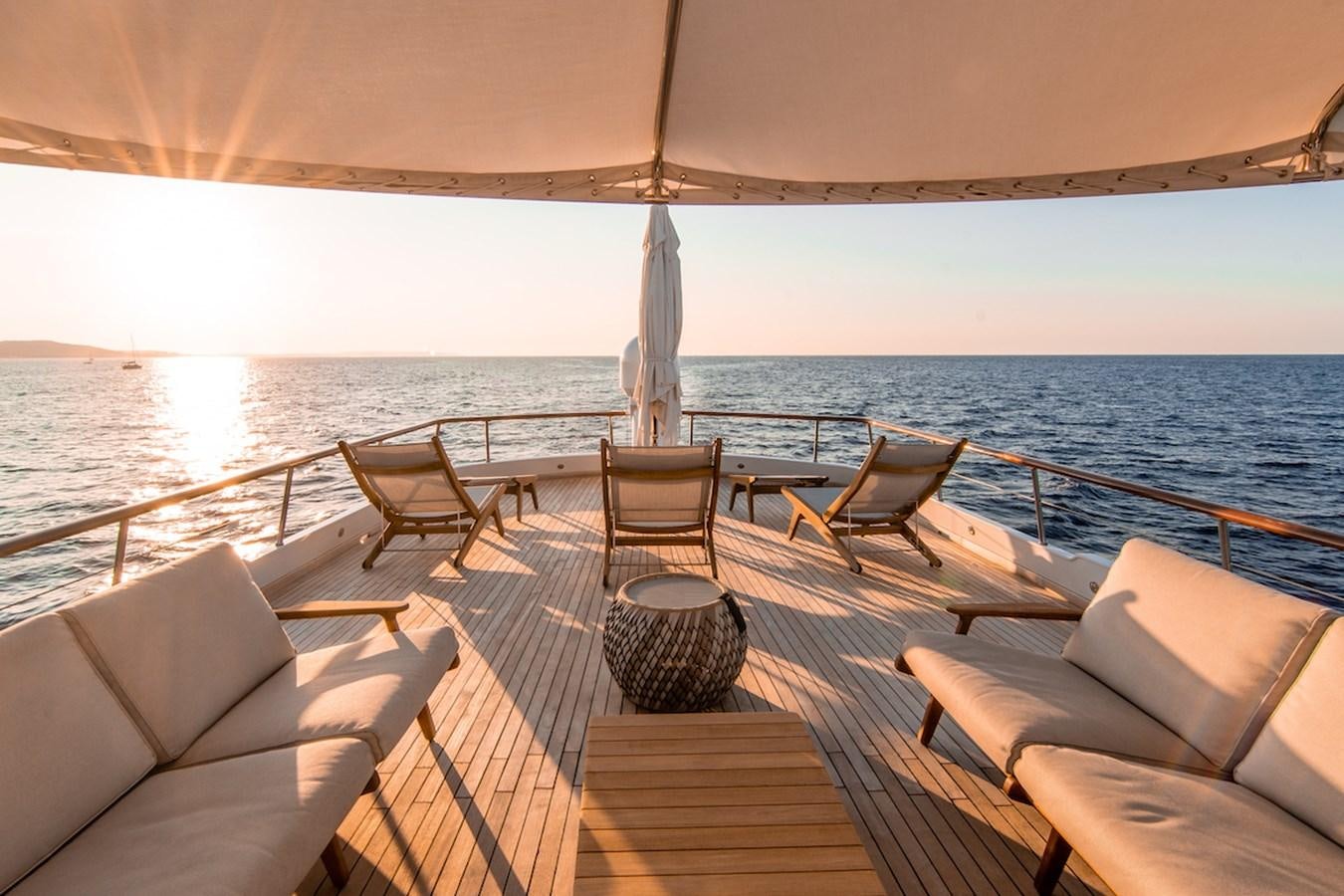 a deck with chairs and a large body of water aboard A&A Yacht for Sale