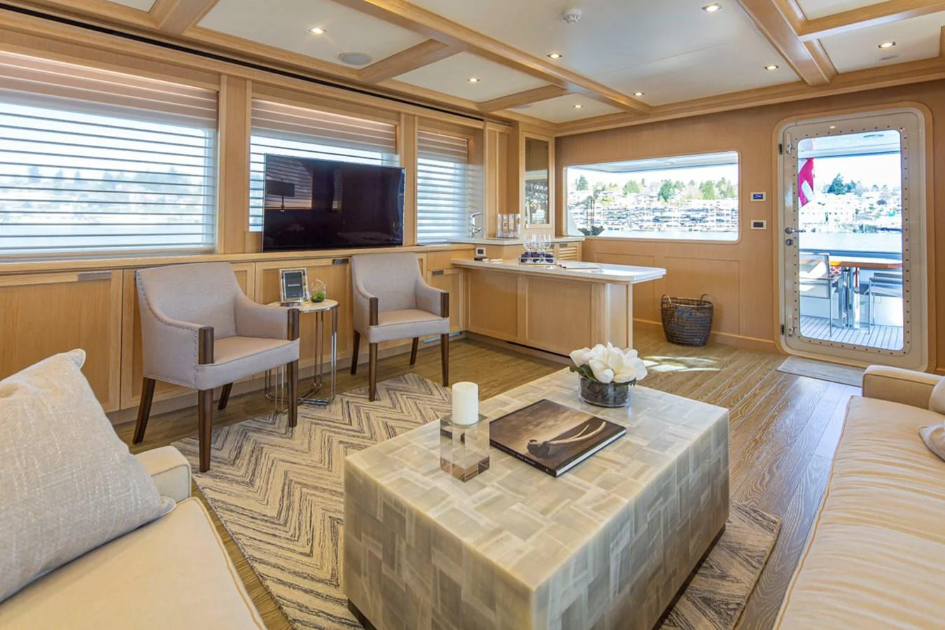 a large living room with a table and chairs aboard 92 PARAGON COCKPIT Yacht for Sale