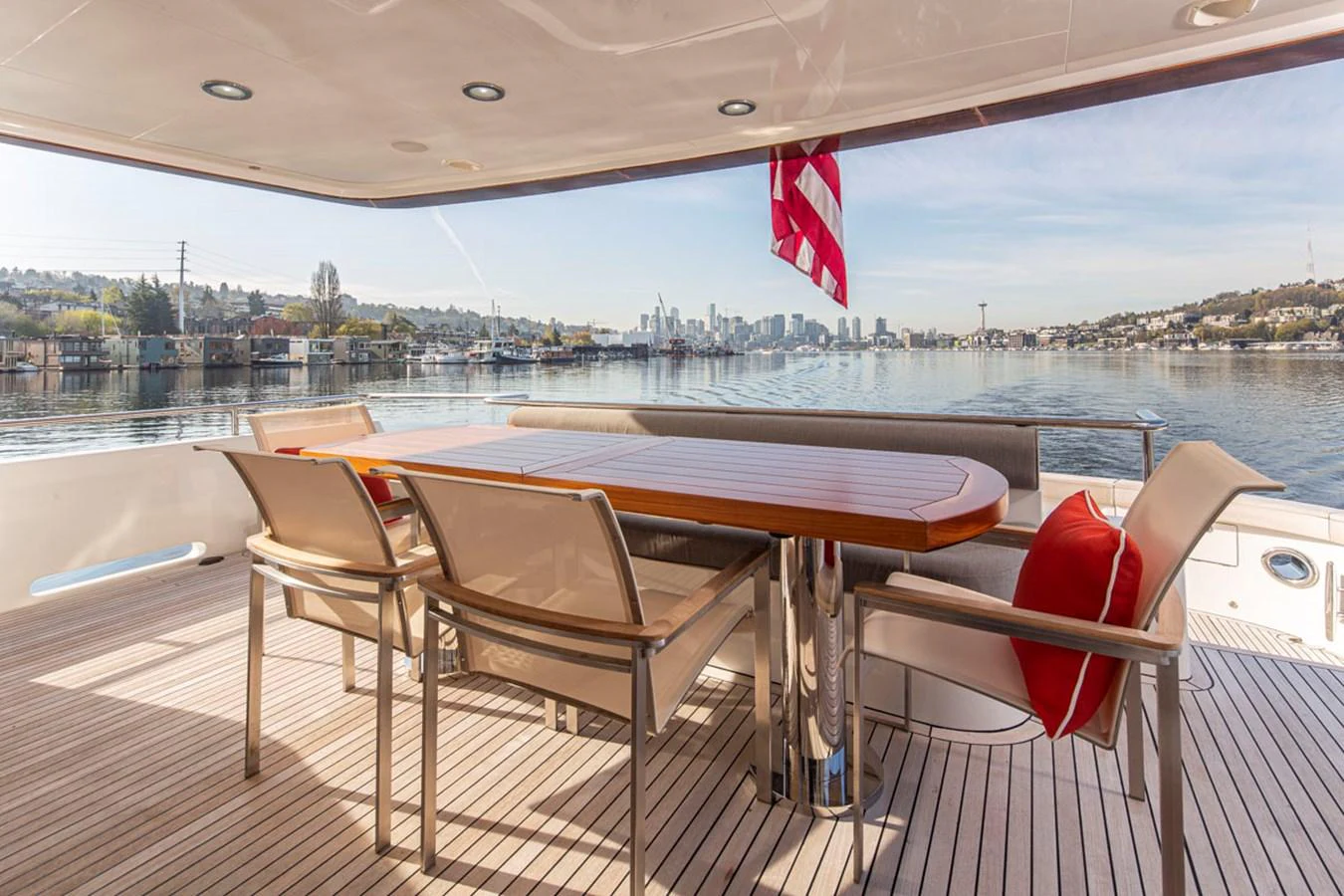 a table and chairs on a deck overlooking a city aboard 92 PARAGON COCKPIT Yacht for Sale