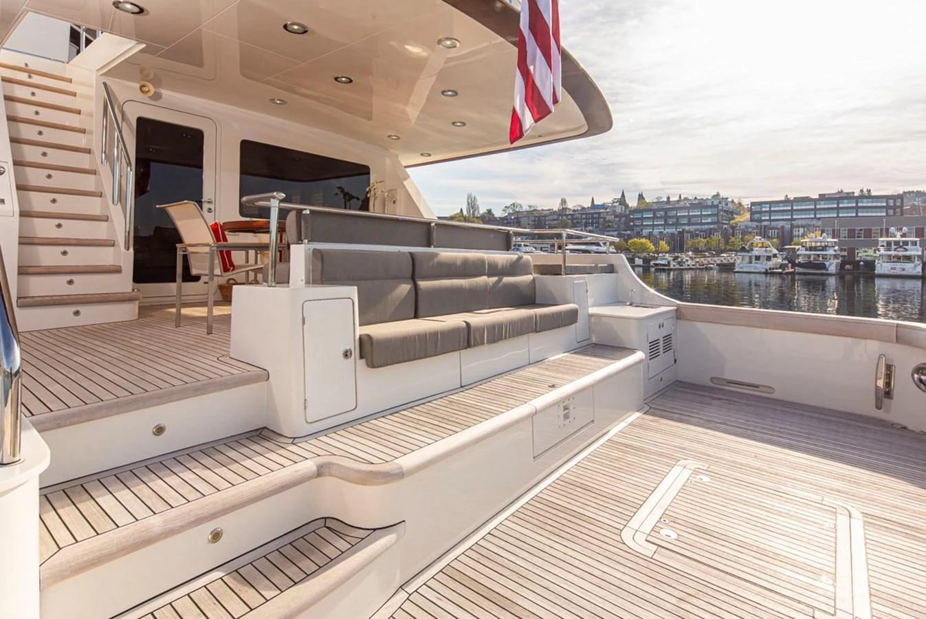a room with a couch and a flag on the wall aboard 92 PARAGON COCKPIT Yacht for Sale