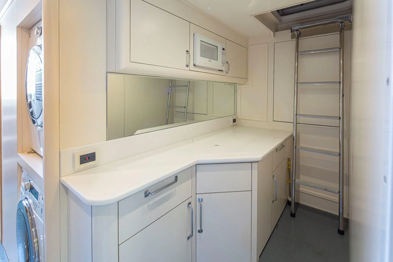 a white kitchen with white cabinets aboard 92 PARAGON COCKPIT Yacht for Sale