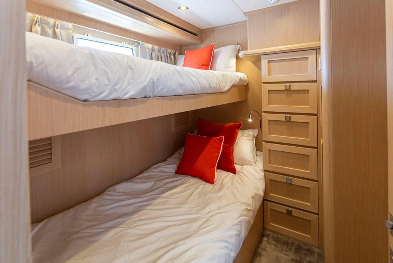a bed with red pillows aboard 92 PARAGON COCKPIT Yacht for Sale