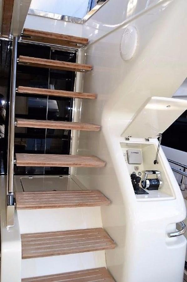 a wooden shelf with a computer aboard BLACK SWAN Yacht for Sale