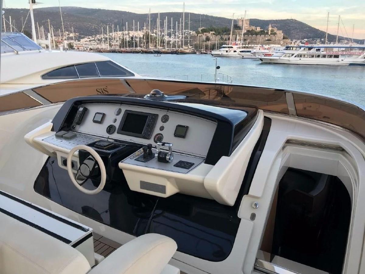 a boat with a steering wheel aboard BLACK SWAN Yacht for Sale