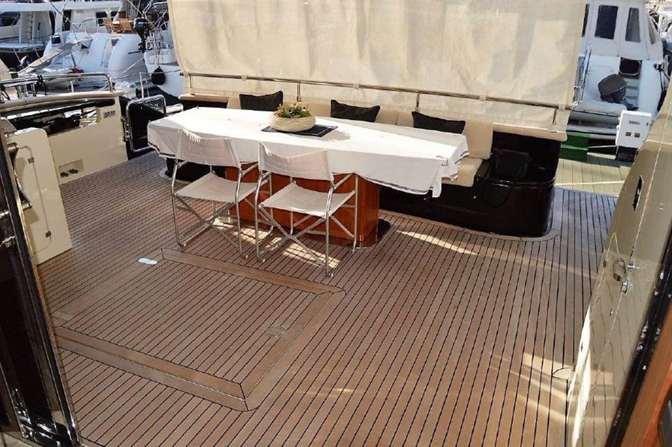 a room with tables and chairs aboard BLACK SWAN Yacht for Sale