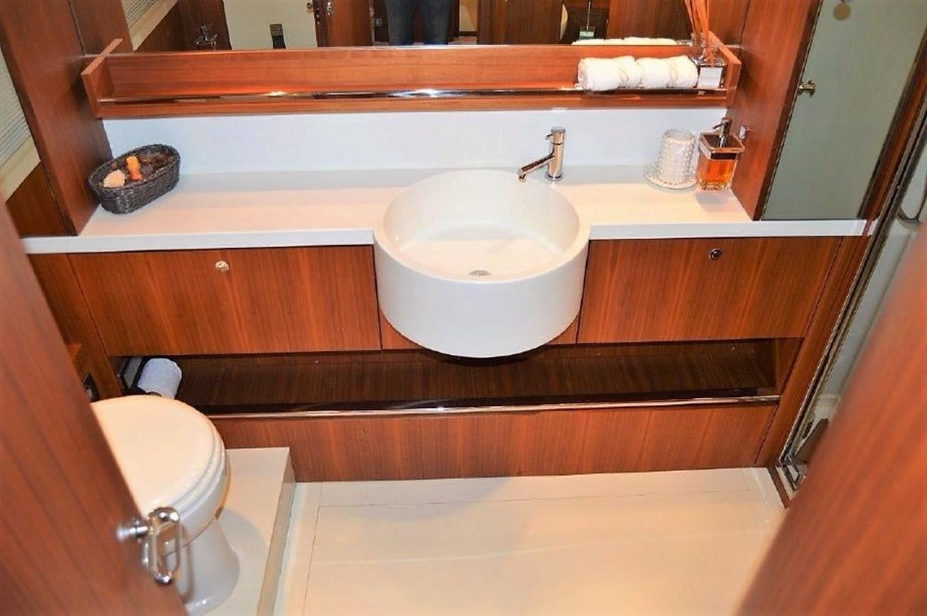 a bathroom with a sink and a mirror aboard BLACK SWAN Yacht for Sale