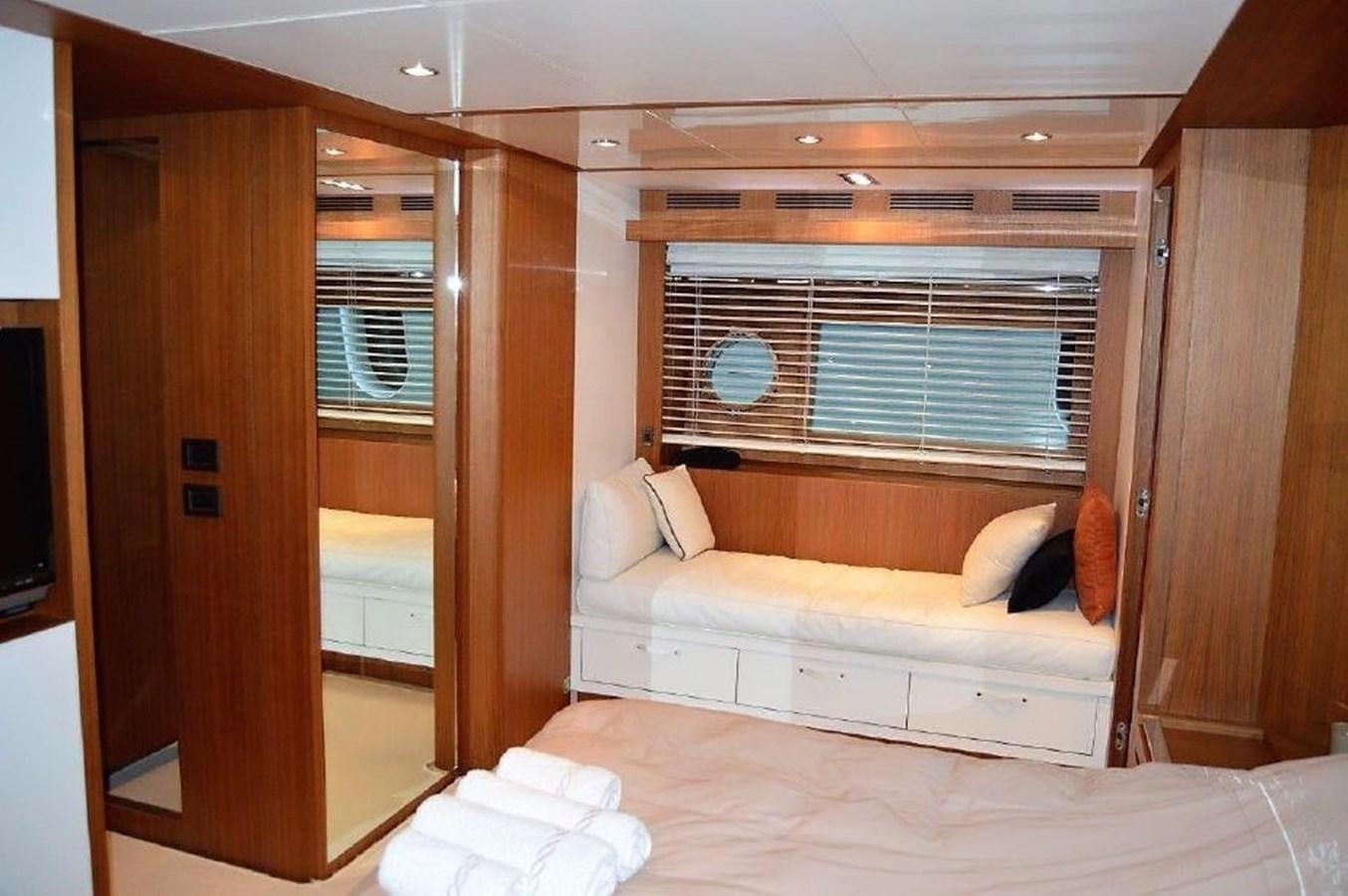 a room with a bed and a window aboard BLACK SWAN Yacht for Sale