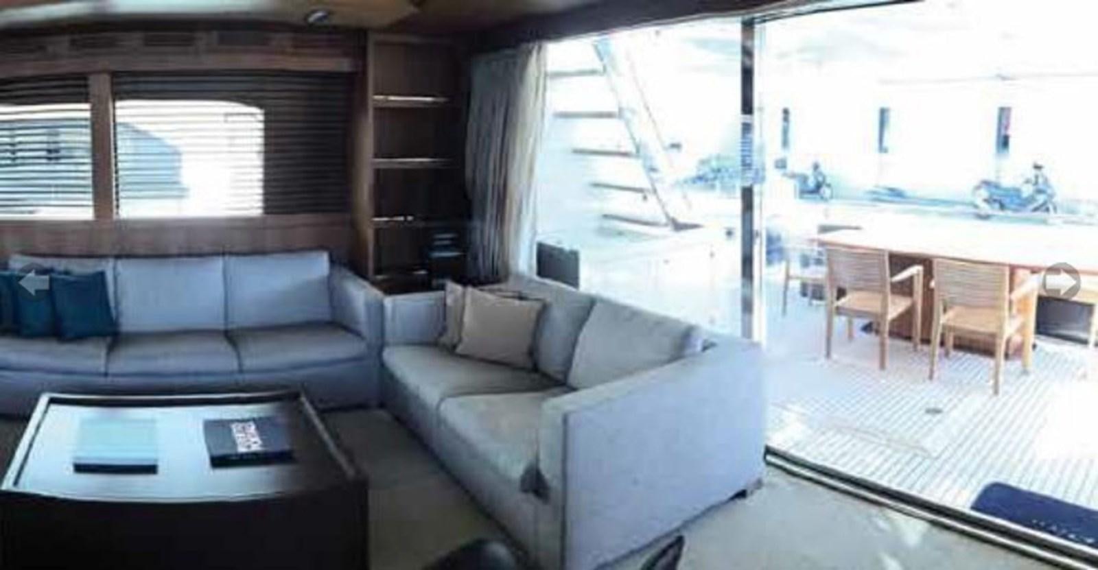 a living room with a couch and a table aboard TAURUS Yacht for Sale