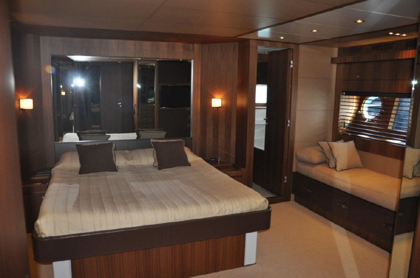 a room with a bed and a couch aboard TAURUS Yacht for Sale