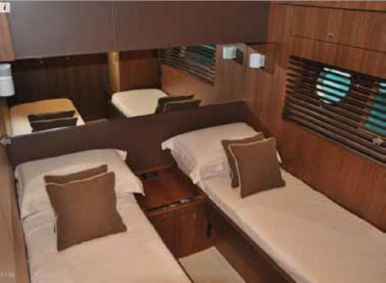 a room with beds and a fireplace aboard TAURUS Yacht for Sale