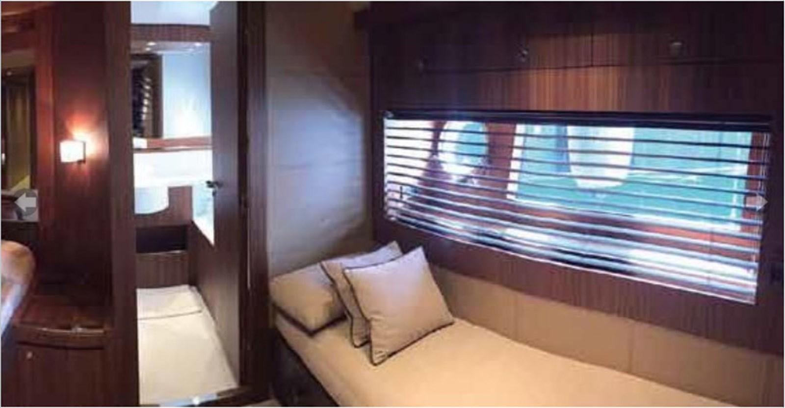 a room with a bed and a window aboard TAURUS Yacht for Sale