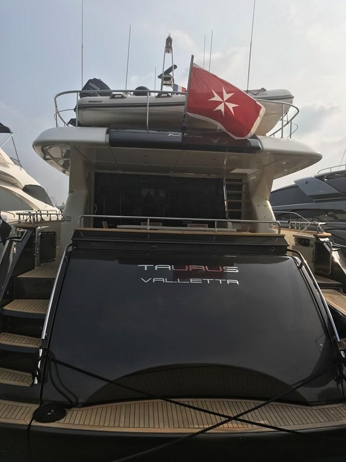 a boat with a flag on the front aboard TAURUS Yacht for Sale