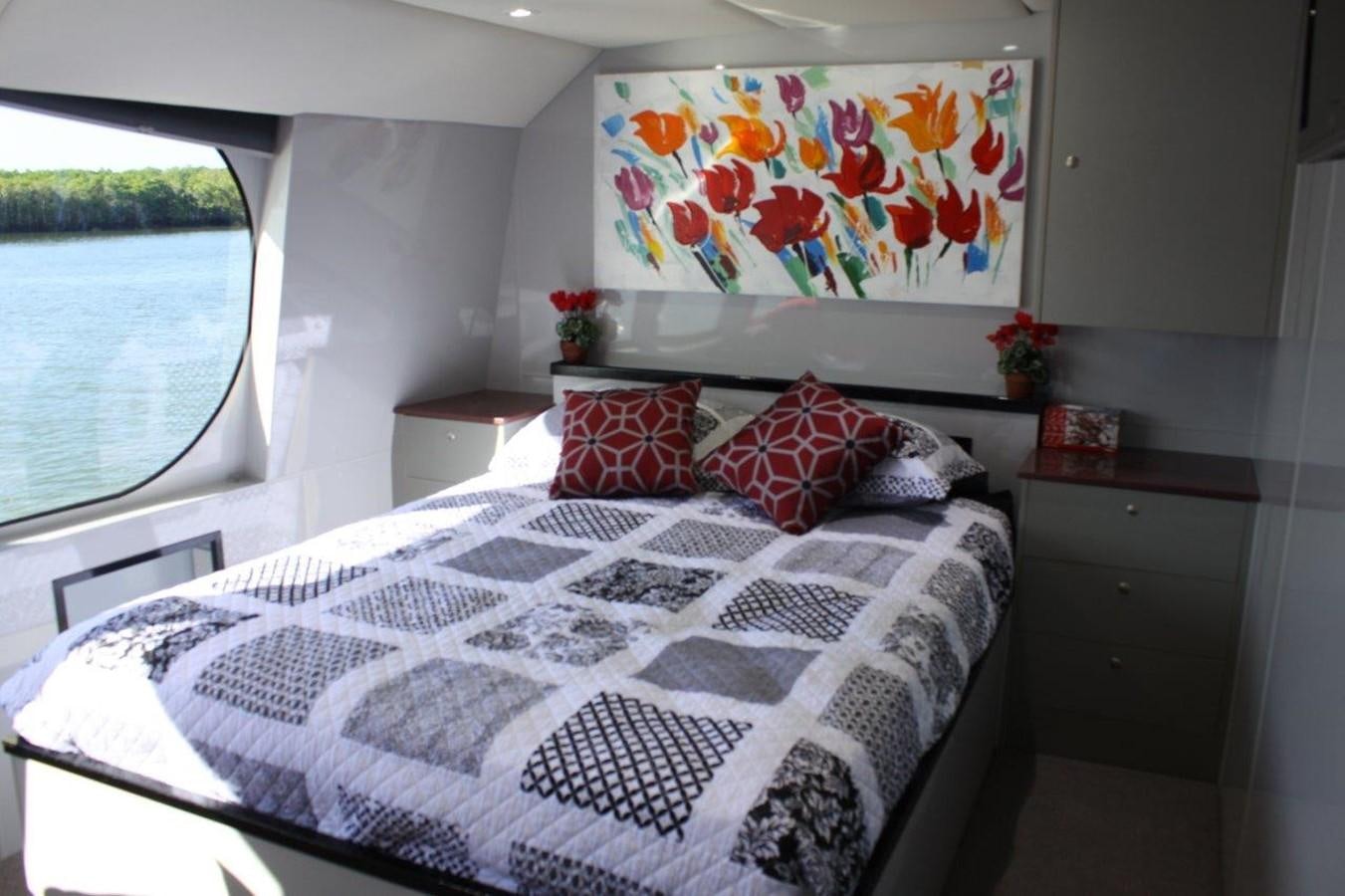 a bed with a flowered comforter aboard MUSHI KHAN Yacht for Sale