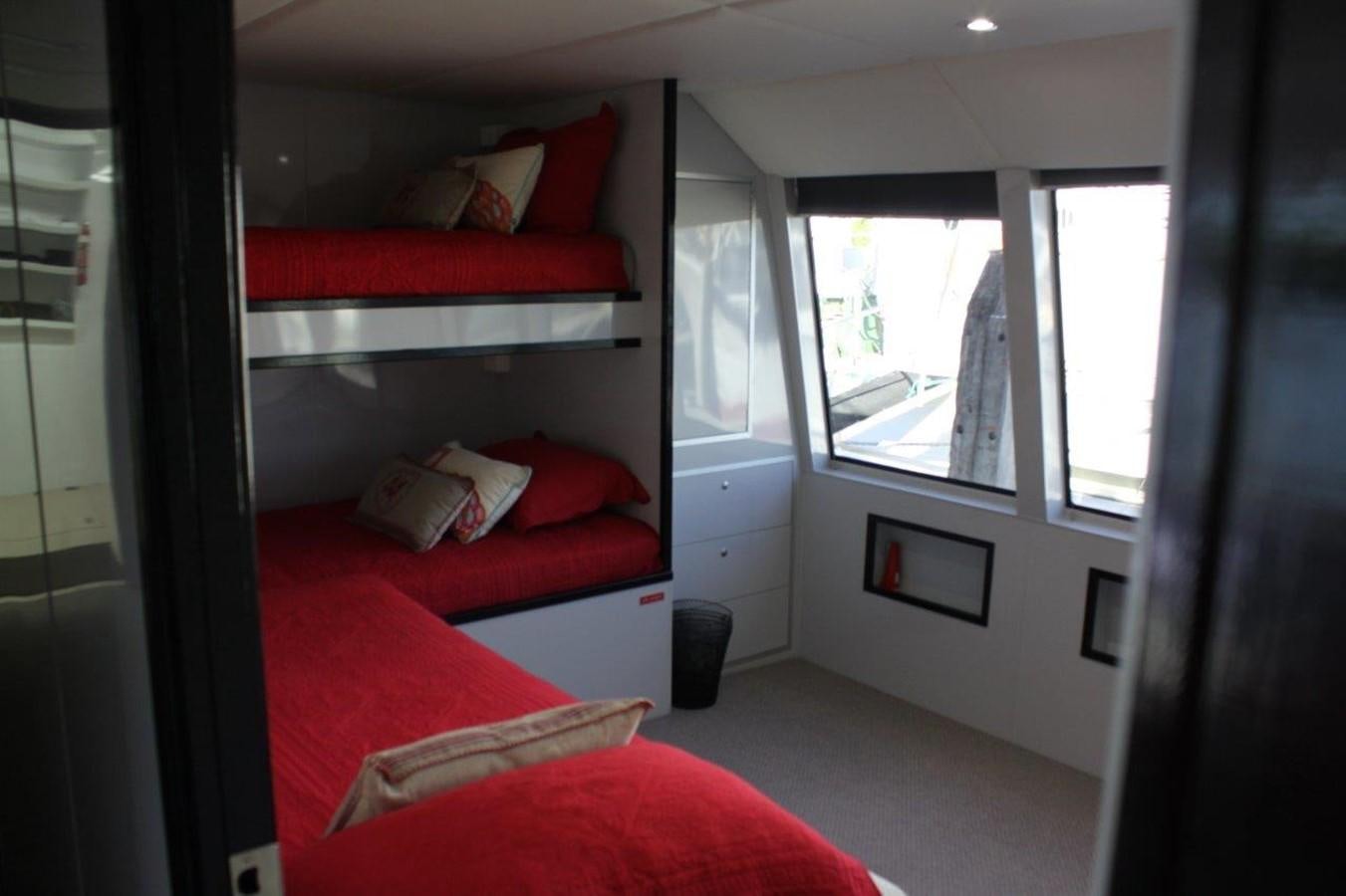 a bedroom with a red bed aboard MUSHI KHAN Yacht for Sale