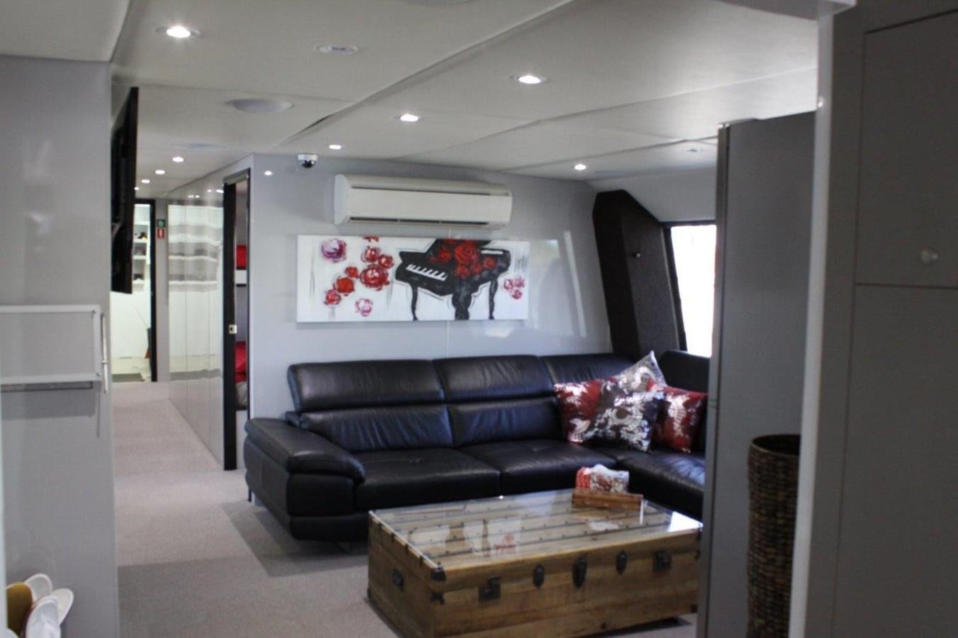 a living room with a black couch aboard MUSHI KHAN Yacht for Sale
