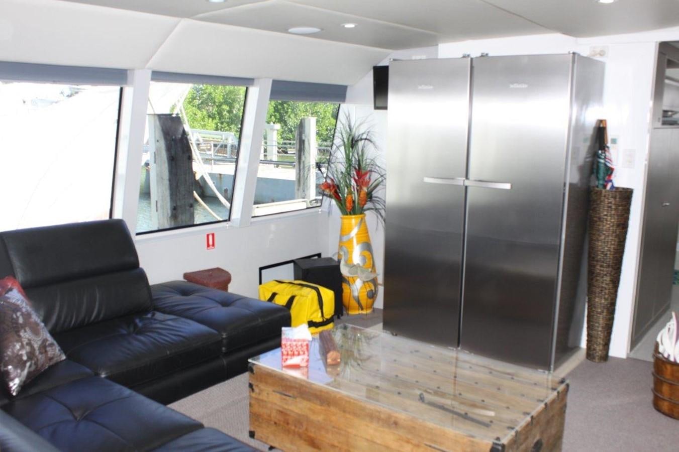 a living room with a large refrigerator aboard MUSHI KHAN Yacht for Sale