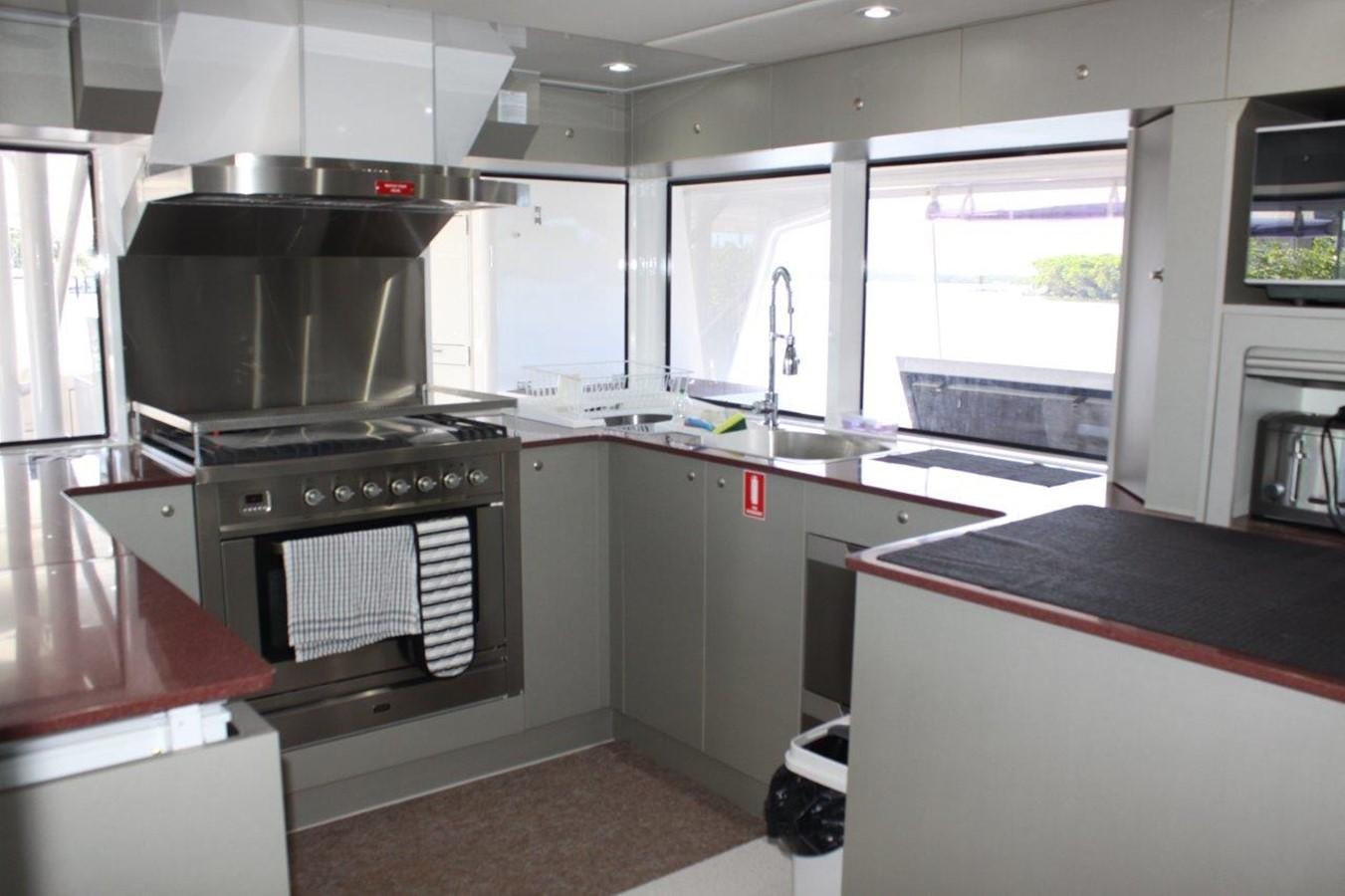 a kitchen with a stove and cabinets aboard MUSHI KHAN Yacht for Sale