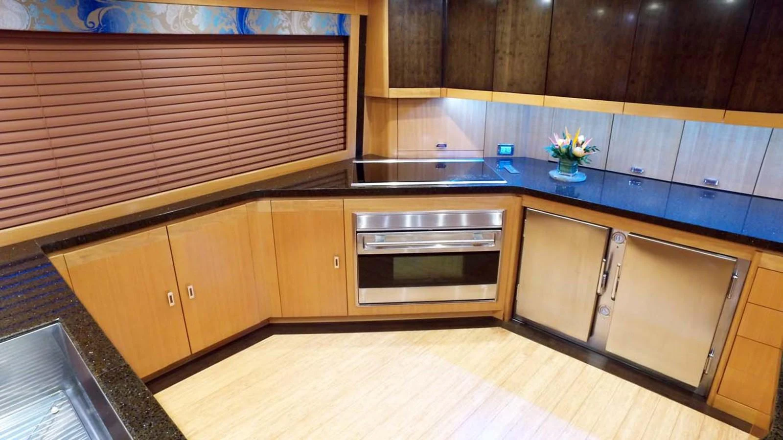 a kitchen with wooden cabinets aboard SILKY Yacht for Sale
