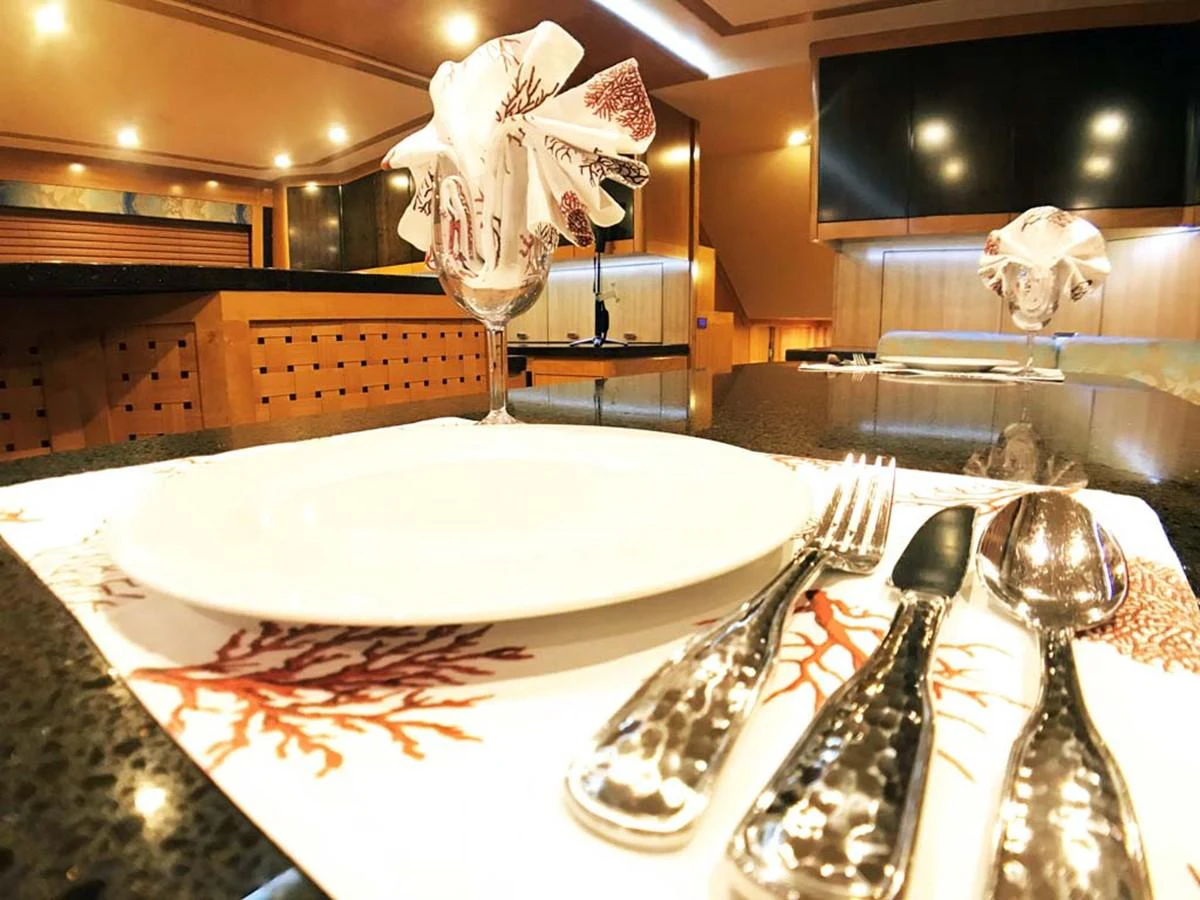 a table with a plate and spoons aboard SILKY Yacht for Sale