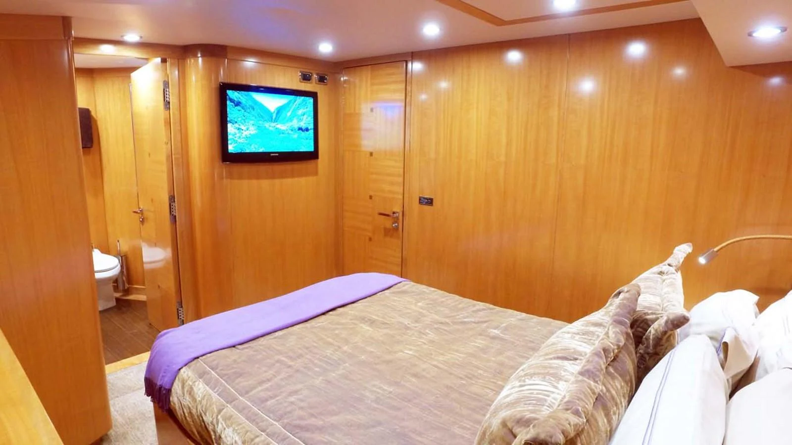 a room with a bed and a television aboard SILKY Yacht for Sale