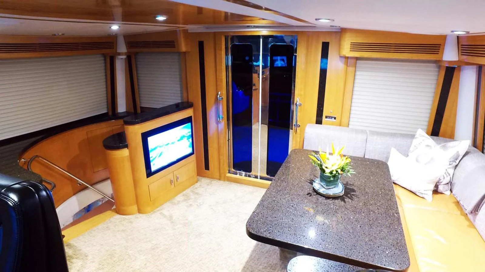 a living room with a tv and a table aboard SILKY Yacht for Sale