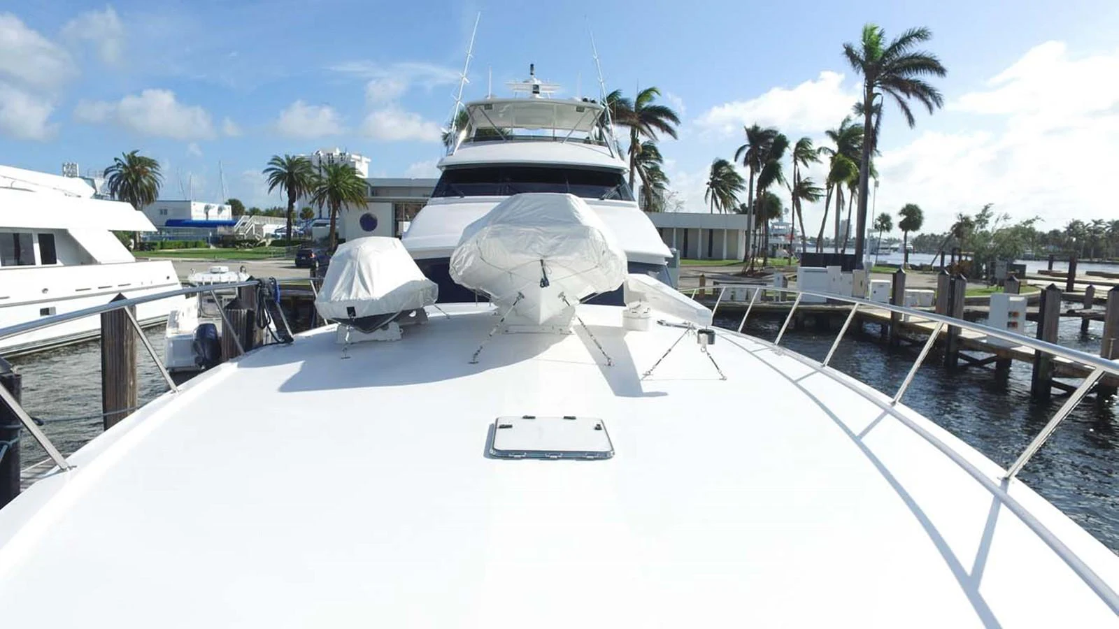 a large white boat docked at a pier aboard SILKY Yacht for Sale