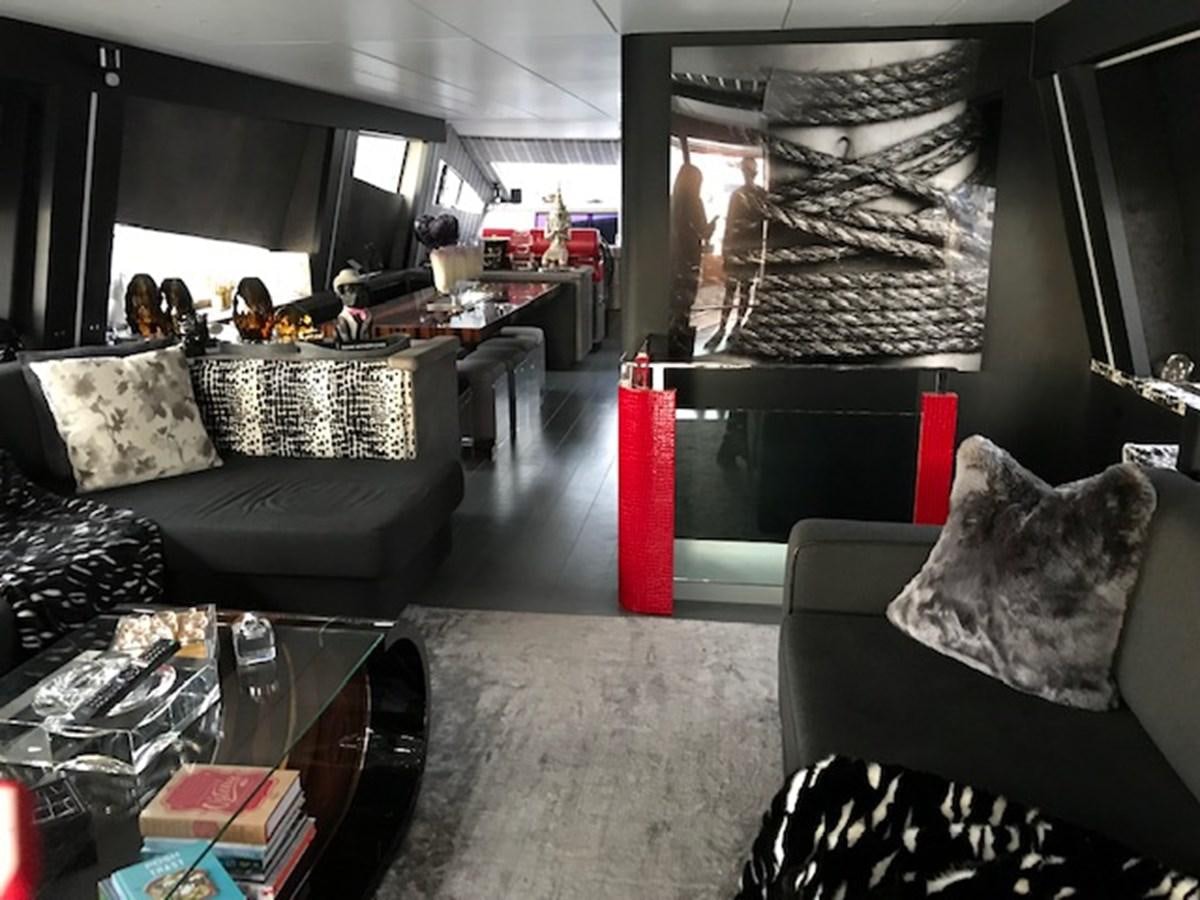 a room with couches and chairs aboard KISSES Yacht for Sale