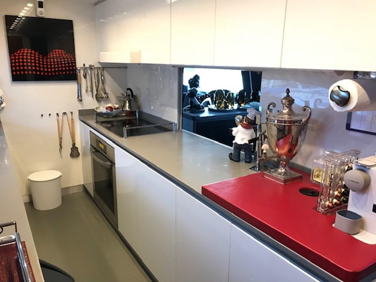 a kitchen with a large island aboard KISSES Yacht for Sale
