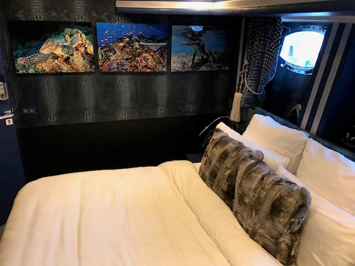 a person lying on a bed aboard KISSES Yacht for Sale