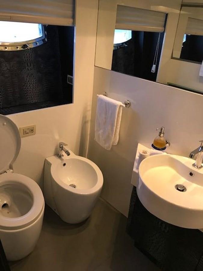 a bathroom with a toilet and sink aboard KISSES Yacht for Sale