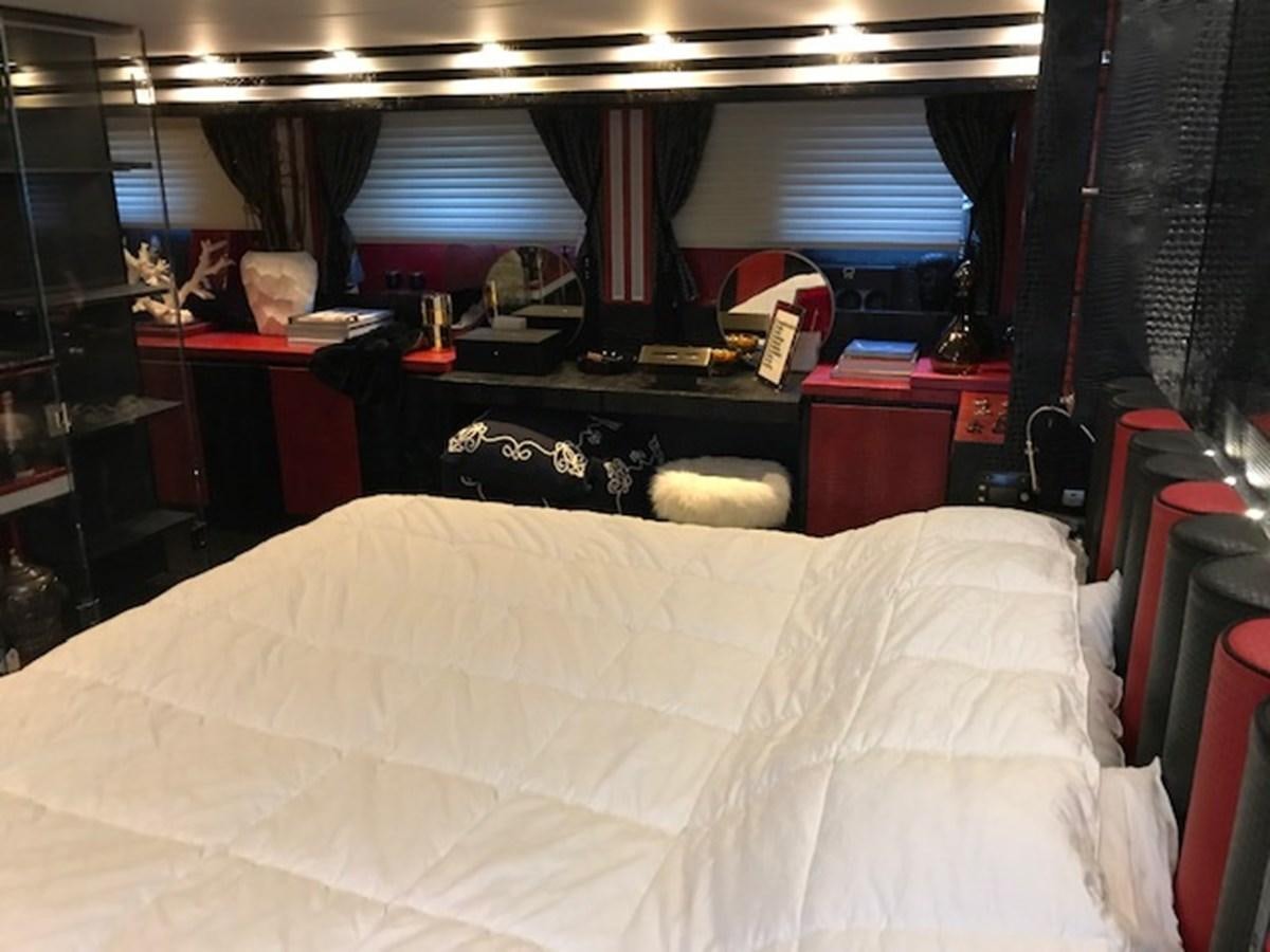 a bed with a white sheet aboard KISSES Yacht for Sale