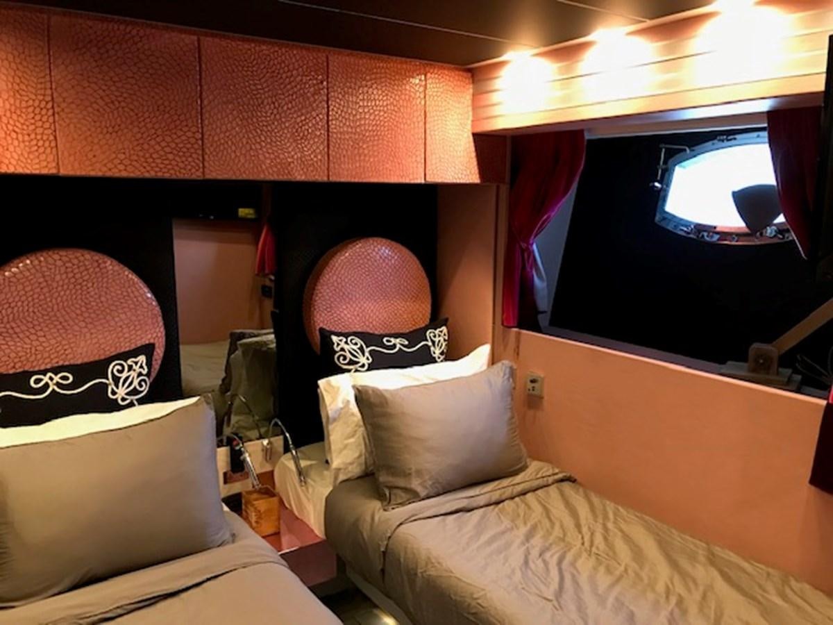 a room with a bed and a television aboard KISSES Yacht for Sale