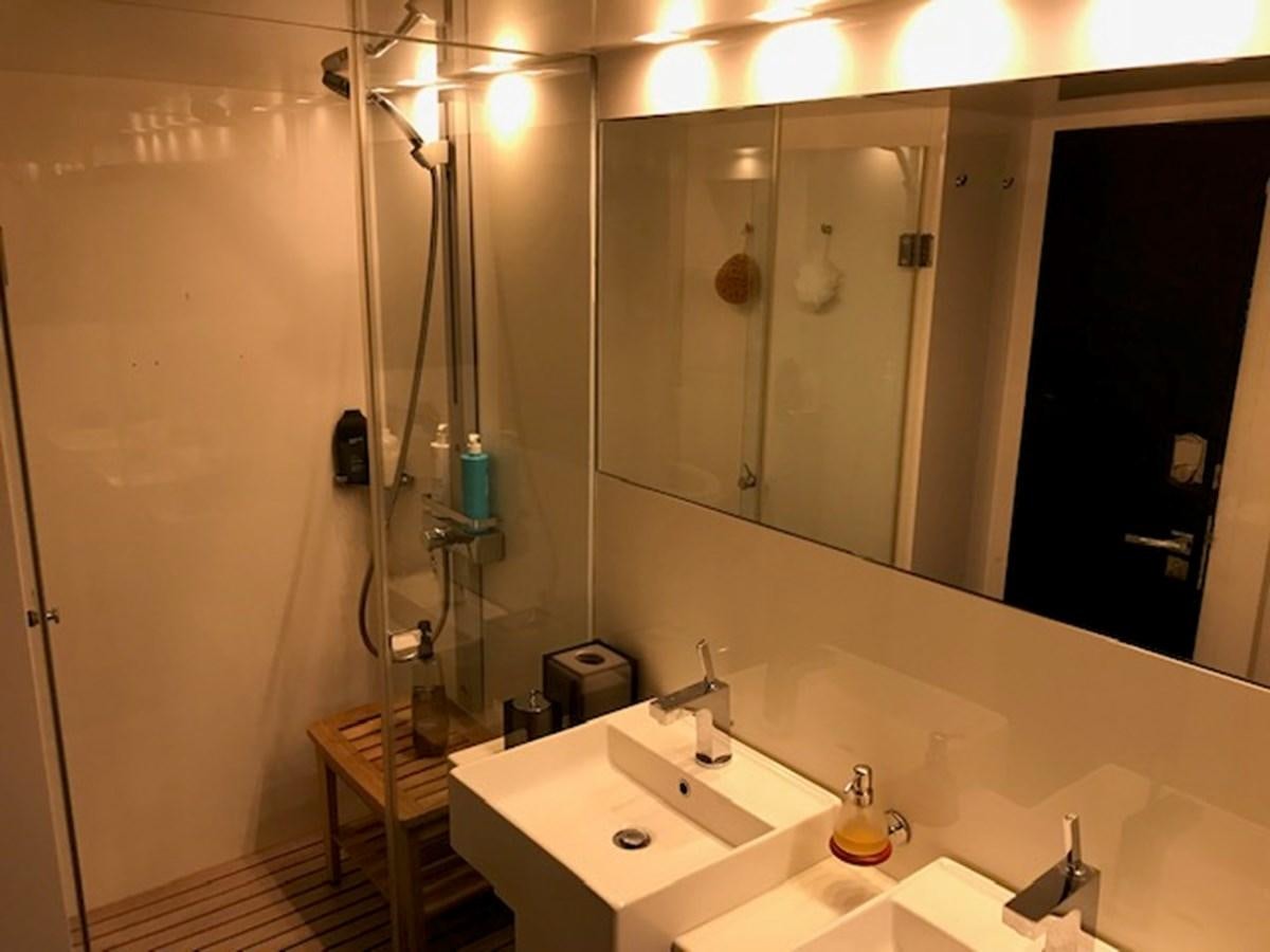 a bathroom with a large mirror aboard KISSES Yacht for Sale