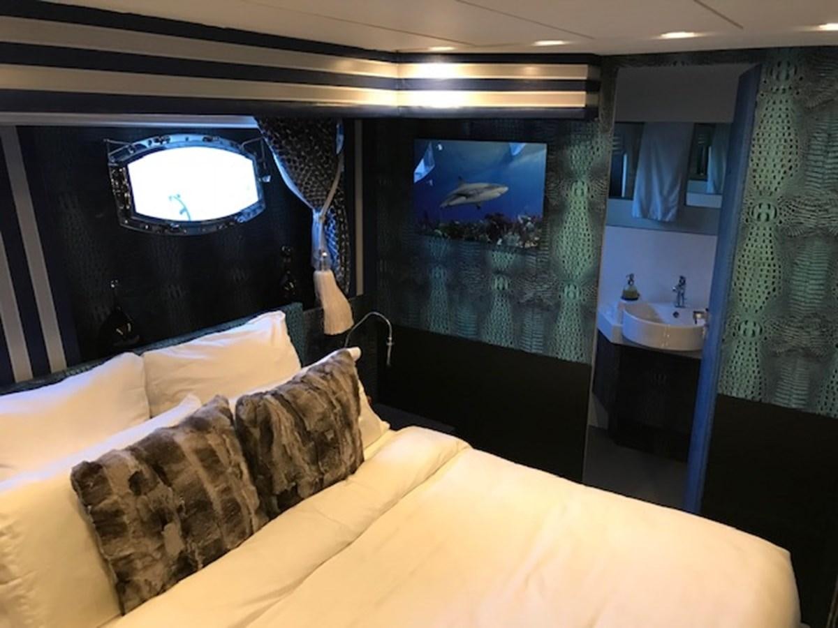 a person standing on a bed aboard KISSES Yacht for Sale