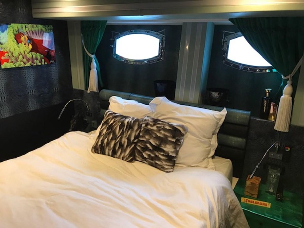 a bed with pillows aboard KISSES Yacht for Sale